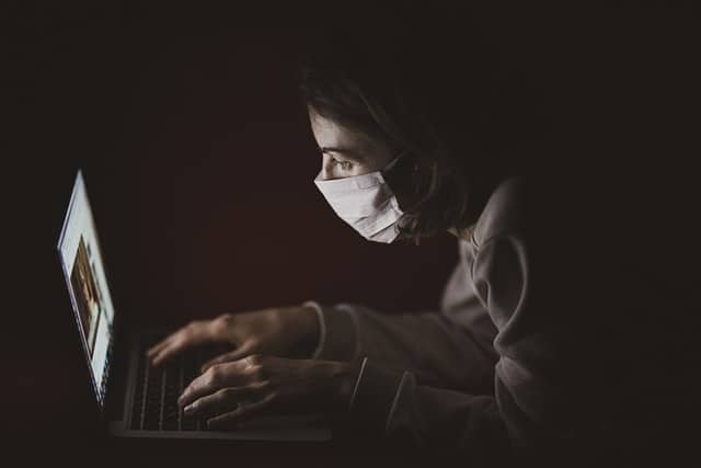 healthcare worker at computer in mask